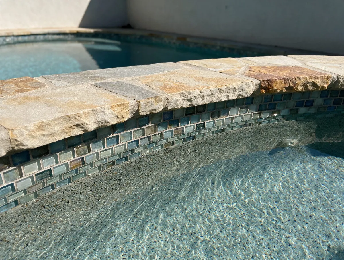 Pool remodel with glass tile and stone coping